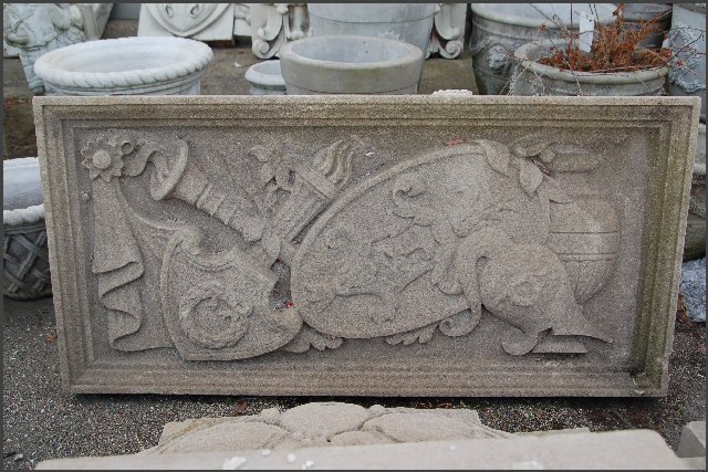 Limestone Panel of Sword , shield and helmet.