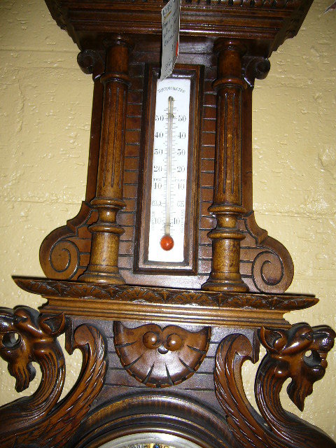 A Highly Carved French Walnut Barometer Features Winged Griffins