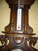 A Highly Carved French Walnut Barometer Features Winged Griffins