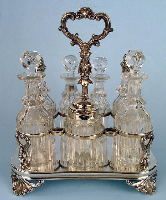 FINE ENGLISH STERLING 7 BOTTLE CASTOR SET FRAME 1861