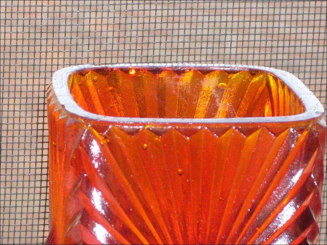 Circa 1886 most unusual RIBBED + BULLSEYE + FOOTED AMBERINA Glass toothpick holder , research indicates C.1886 Ribbed effect on outer surface, Reverse Bullseye each at different height on panels. Footed.