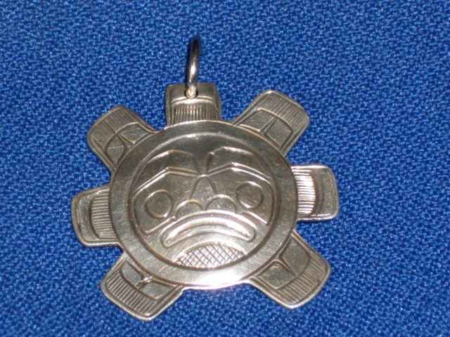 old British Columbia _1st. Nations _Indian _Native Art in Sterling Silver . Sun Spirit Mask symbol pendant . The Skill of Native carver. Beautiful. Monogram signature ( N S ) Circa 1970