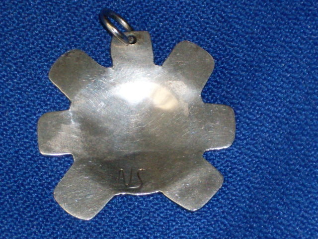 old British Columbia _1st. Nations _Indian _Native Art in Sterling Silver . Sun Spirit Mask symbol pendant . The Skill of Native carver. Beautiful. Monogram signature ( N S ) Circa 1970