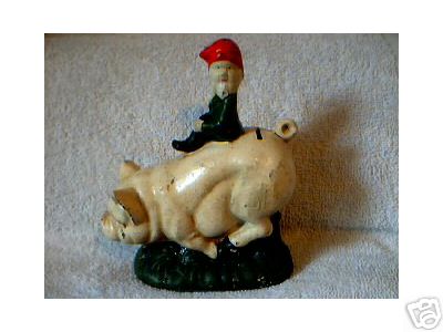 CAST IRON PIG BANK ELF RIDE