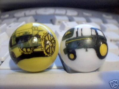 TWO JOHN DEERE MARBLES