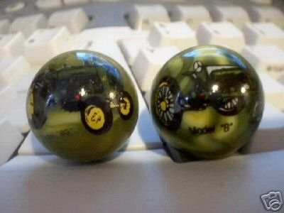 TWO JOHN DEERE MARBLES