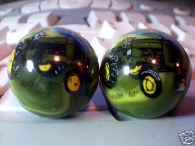 TWO JOHN DEERE MARBLES