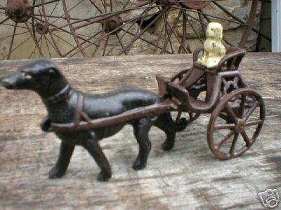 CAST IRON DOG IN TWO-WHEEL CART NR