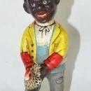 BLACK MAN HOLDING CHICKEN CAST IRON