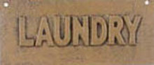 ONE TAN VINTAGE STYLE CAST IRON TAN LAUNDRY SIGN