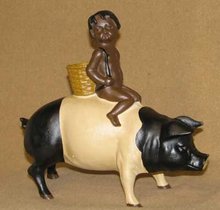 CAST IRON BLACK AMERICANA BOY RIDING BLACK-WHITE PIG