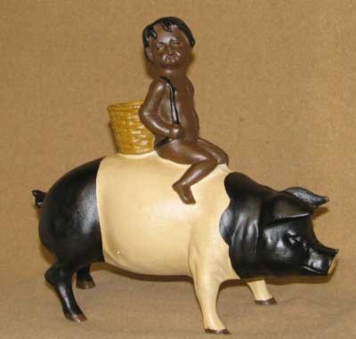 CAST IRON BLACK AMERICANA BOY RIDING BLACK-WHITE PIG