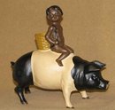 CAST IRON BLACK AMERICANA BOY RIDING BLACK-WHITE PIG