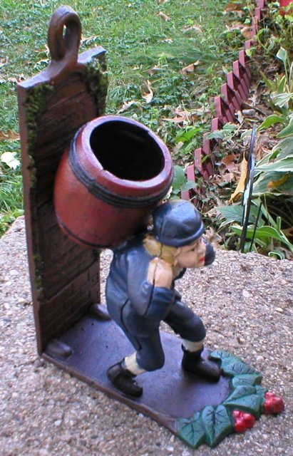 BOY CARRYING BARREL BOOKEND CAST IRON