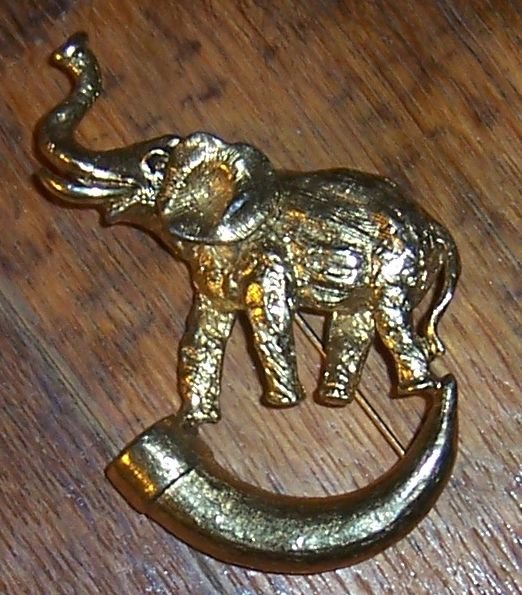 Vintage Gold Tone Pin Elephant with Raised Trunk Standing on a Horn