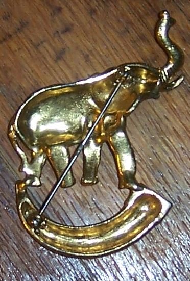 Vintage Gold Tone Pin Elephant with Raised Trunk Standing on a Horn