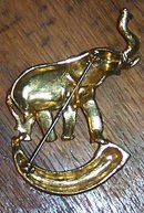 Vintage Gold Tone Pin Elephant with Raised Trunk Standing on a Horn