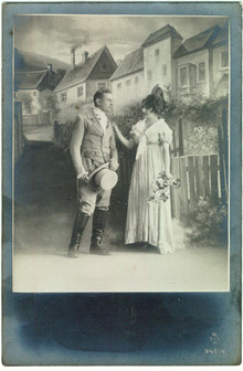 Photo postcard of Couple Dressed Up on Set