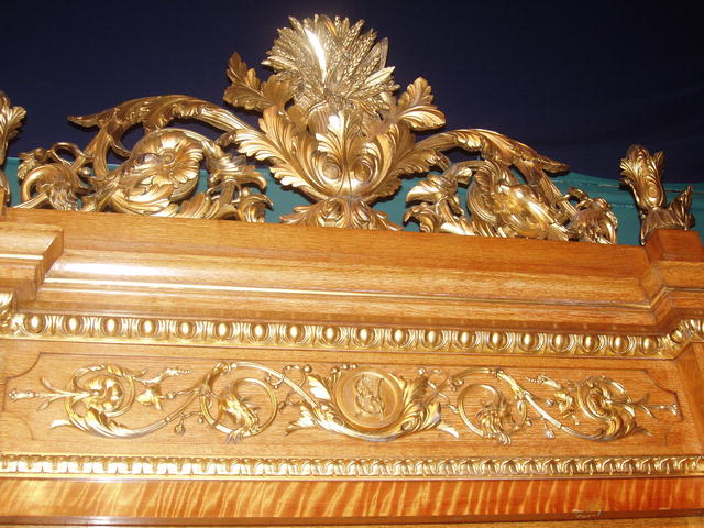 A Museum Quality Oak Display Cabinet with fine quality Giltwood Carving to the Crown and Body of the cabinet.
