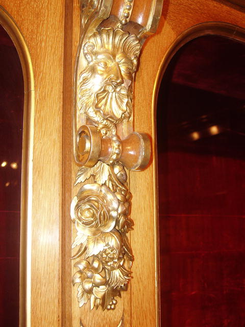 A Museum Quality Oak Display Cabinet with fine quality Giltwood Carving to the Crown and Body of the cabinet.