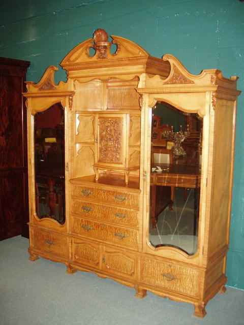 An excellent quality English 19th century Armoire in Satinwood with finely detailed carving.