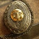 Vintage gunmetal moon locket Whimsical face in mixed metals