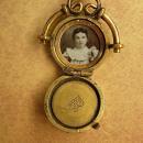 ANtique watch fob locket with little girl photo Flip fob ornate metal work