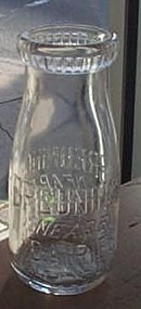 Breuninger Nearby Dairies embossed half-pint milk bottle