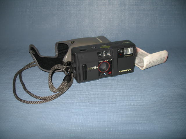 Olympus Infinity 35mm camera with built-in flash, case, and instruction booklet