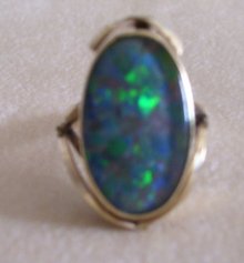 Ladys Firey Opal Doublet Ring- Marked 9ct.- Weighs 5.6 Grams