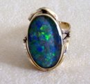 Ladys Firey Opal Doublet Ring- Marked 9ct.- Weighs 5.6 Grams