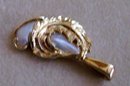 A Ladys beautiful Natural Pearl Pendant wrapped in 14K Yellow Gold Leafs
