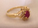 Ladys Ring: .75 cts.Ruby and .33cts. Diamonds:,4.40 grms.Yellow gold