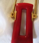 A Trifari Red Bakelite Necklace On Gold Chain