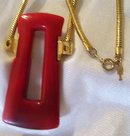 A Trifari Red Bakelite Necklace On Gold Chain