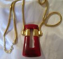 A Trifari Red Bakelite Necklace On Gold Chain