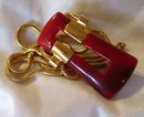 A Trifari Red Bakelite Necklace On Gold Chain
