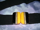 A Vintage Bakelite black and yellow Belt buckle on Black cloth ladys belt