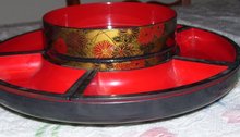 An Asian vintage plastic Lazy Susan Red and Black Decrative arts rotating tray with 6 compartments