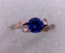A ladys 1 carat London Blue Topaz Ring with two white topaz