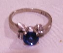 A ladys 1 carat London Blue Topaz Ring with two white topaz