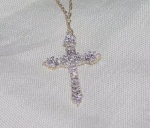 A Ladys White Diamond and Gold Cross Pendant