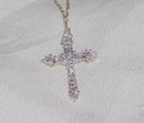 A Ladys White Diamond and Gold Cross Pendant