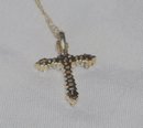 A Ladys White Diamond and Gold Cross Pendant