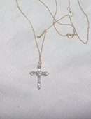 A Ladys White Diamond and Gold Cross Pendant
