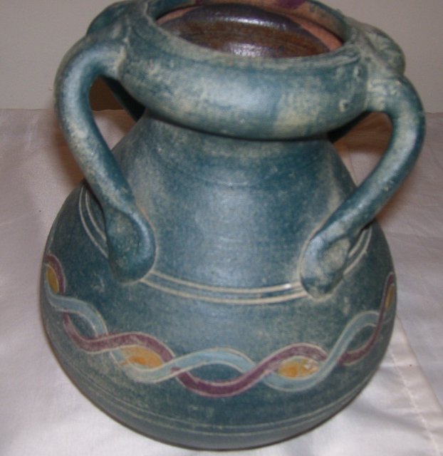 A Large green pottery vase with 4 applied handles, hand turned clay vase