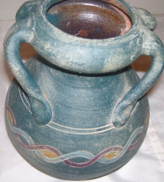 A Large green pottery vase with 4 applied handles, hand turned clay vase