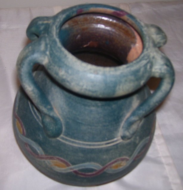 A Large green pottery vase with 4 applied handles, hand turned clay vase