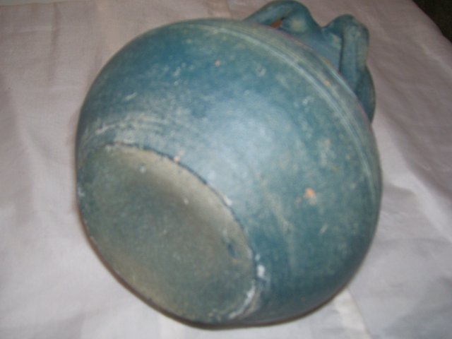A Large green pottery vase with 4 applied handles, hand turned clay vase