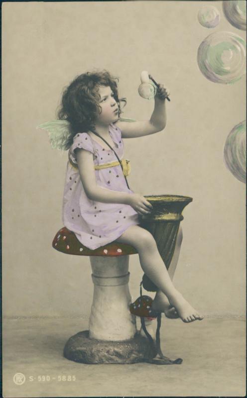 Vintage postcard, tinted photo of a little girl with bubbles